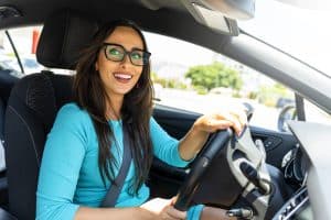 Business woman driving a rented luxury car for her company meetings
